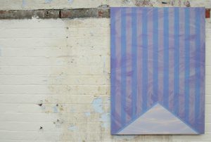 An image of a painting in a gallery, it features blue and lilac vertical stripes and swirling textures.