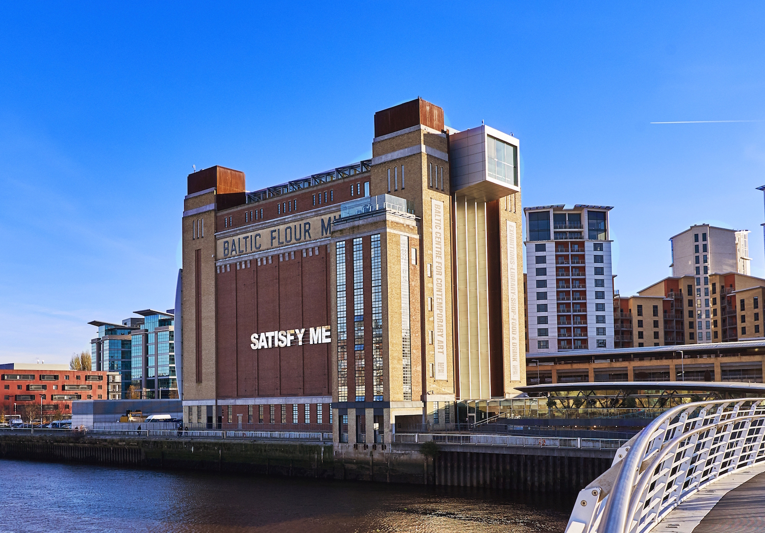 BALTIC Centre for Contemporary Art building, with the words 'SATISFY ME' across the front of the brick facade.