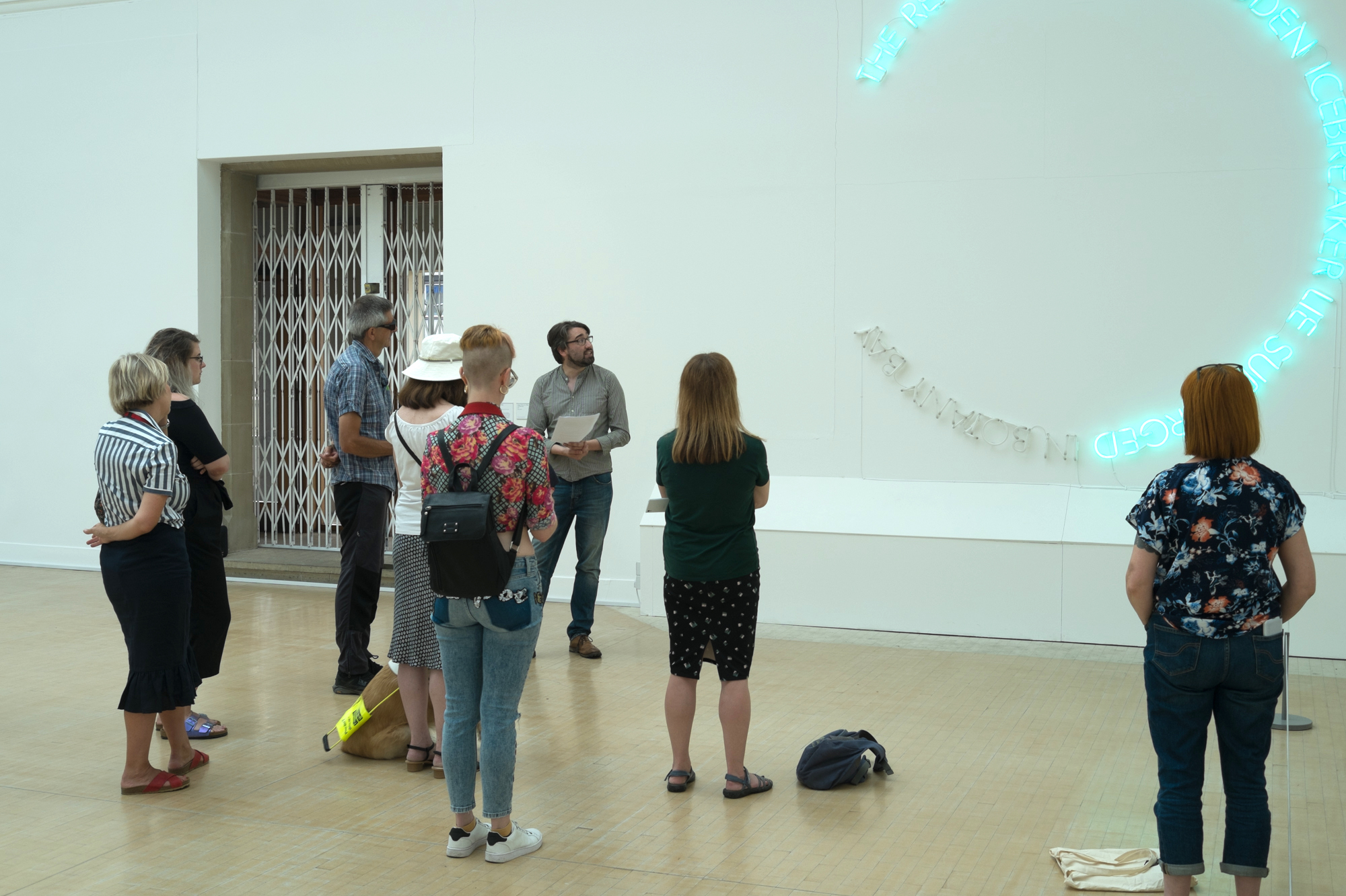 People gather in a gallery space for a performance.