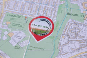 A map with a sticker showing 'You are here'.