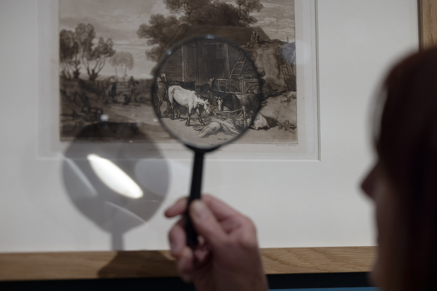 A closeup of a turner print seen through a magnifying glass