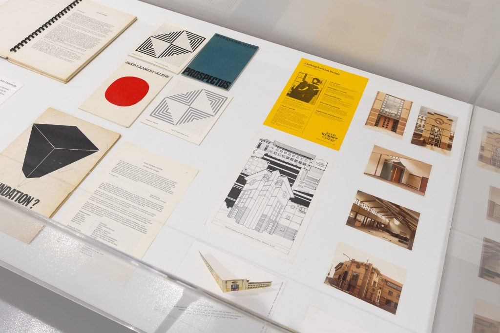 Top view of a vitrine full of pamphlets and photos of Leeds college of art.