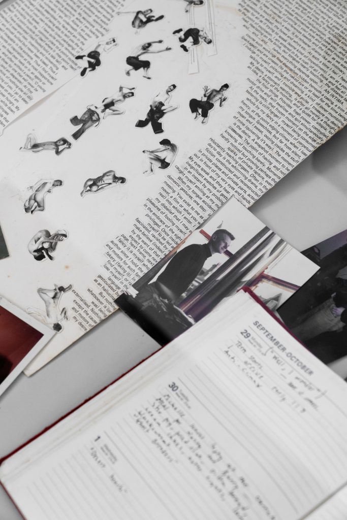 An assortment of archival material, including a photo of a young person dressed in black sat by a window and an open diary page with hand-written text.