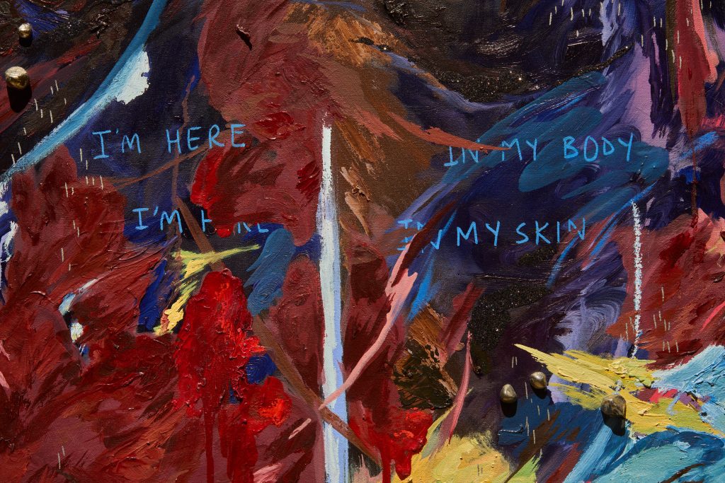 Close-up of abstract painting with feathered strokes of deep reds, blues and purples, and the words 'I'm here in my body / I'm here in my skin'