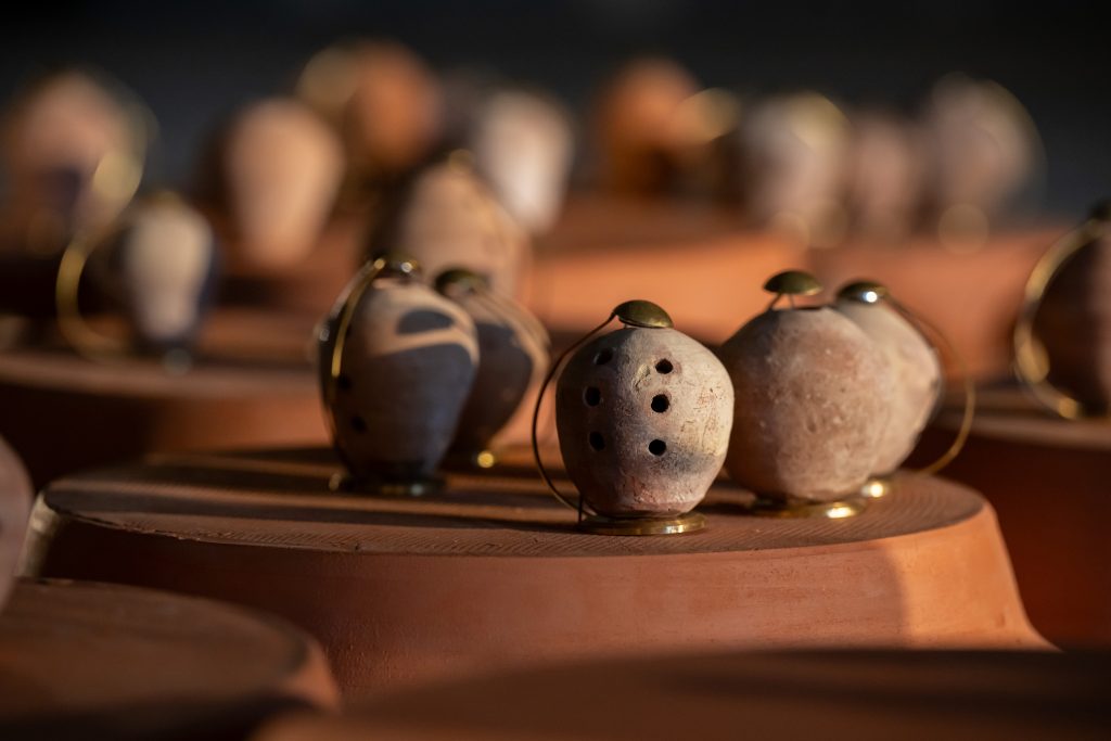 A close up which shows the borindos small round shape and air holes in a row for playing, with golden bases and wires