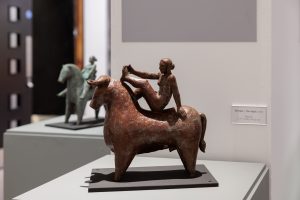 a sculpture of a woman riding a bull