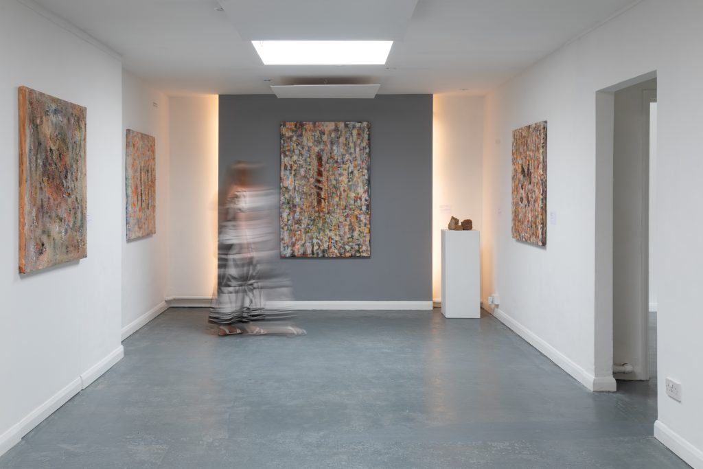 Installation view of Oliver Benoit: Roots Through Ruins at Coreset. Four large abstract paintings are displayed in a plain gallery space with white walls and a grey floor.