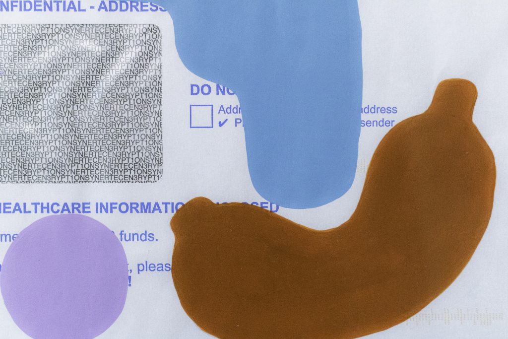 Blue, brown and lilac shapes painted onto an NHS envelope