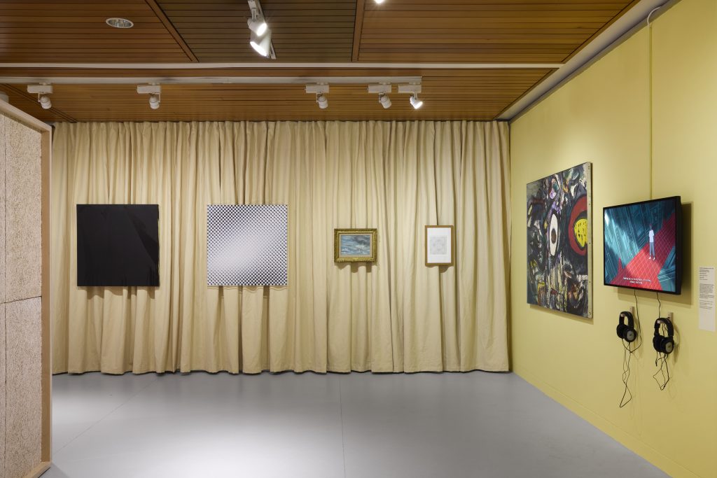 A yellow curtained wall with four square and rectangular works hung in a horizontal line