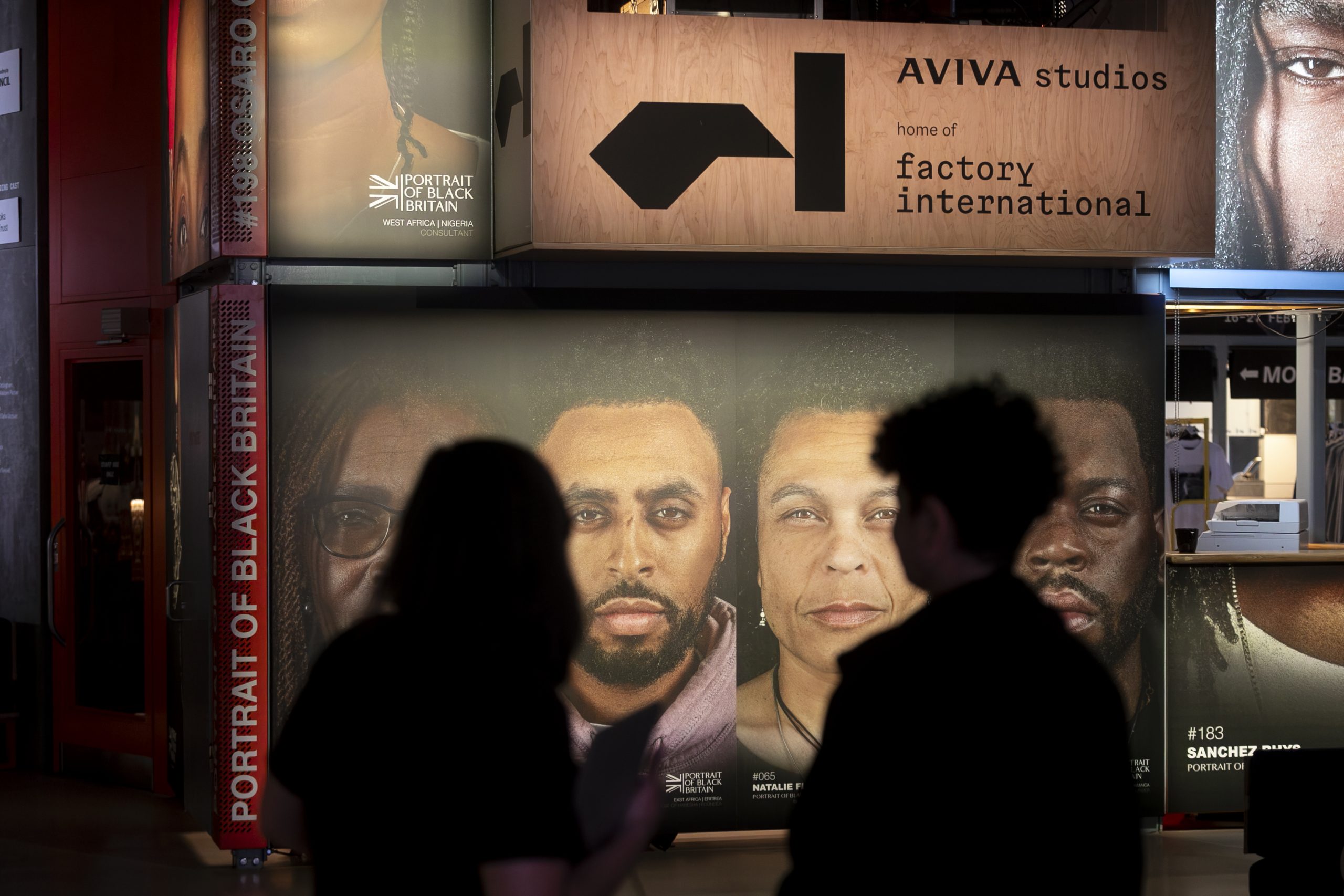 Two people observe a gallery display.
